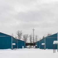 Blue Storage Sheds receding in distance